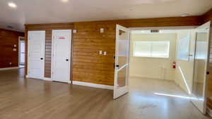 Interior space with wooden walls, recessed lighting, and wood finished floors