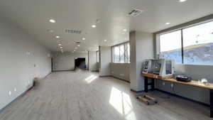 Office featuring light wood finished floors and recessed lighting
