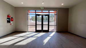 Unfurnished room featuring light wood-type flooring, french doors, and recessed lighting