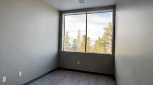 Spare room with light wood-style floors and baseboards