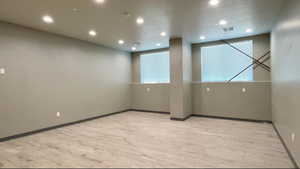 Spare room with light wood-type flooring and recessed lighting