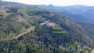 Aerial overview of property's location with property parcel outlined and a mountain backdrop