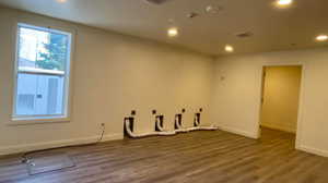 Spare room with dark wood finished floors, recessed lighting, and a smoke detector