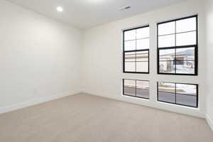 Empty room with light carpet and baseboards