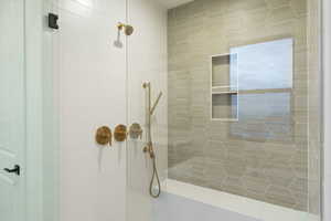 Bathroom featuring tiled shower