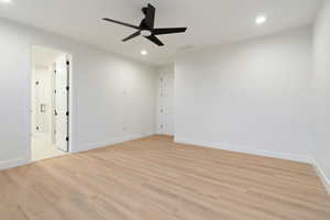 Unfurnished bedroom with light wood finished floors, a ceiling fan, and recessed lighting