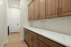 Laundry room featuring light wood-style flooring and recessed lighting