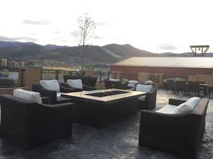 View of patio / terrace featuring an outdoor fire pit, a mountain view, and an outdoor living / dining area