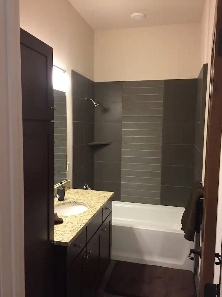 Bathroom featuring vanity and tub / shower combination