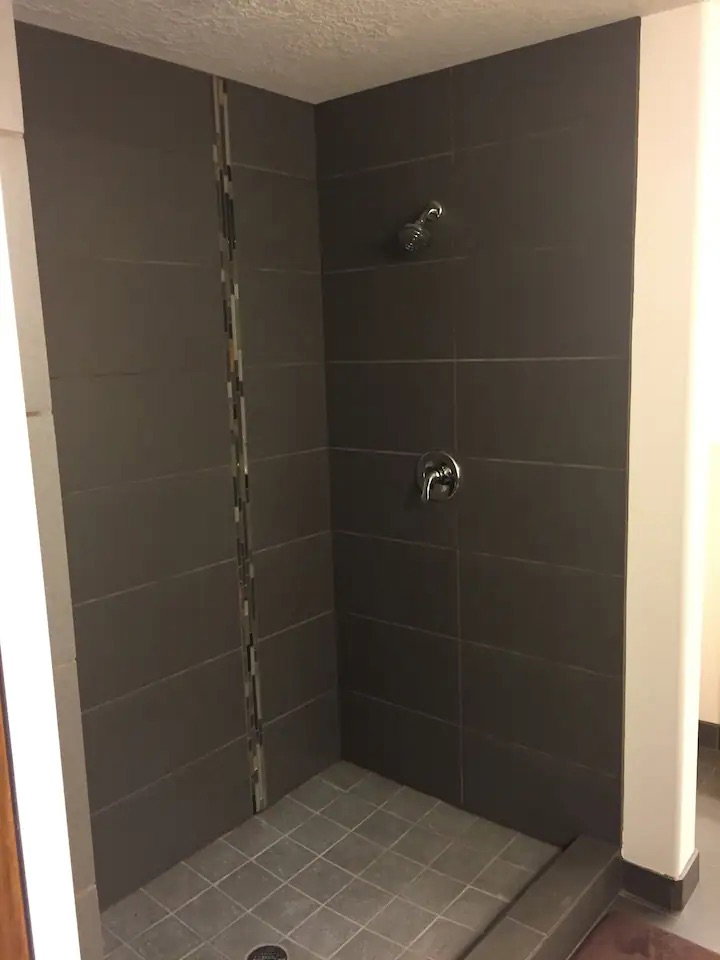 Full bath with a stall shower and a textured ceiling