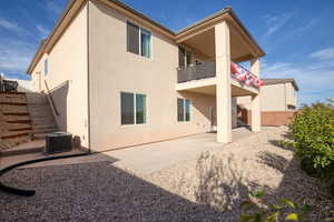 Back of house featuring a patio area, stucco siding, a balcony, and a fenced backyard