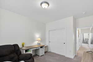 Carpeted home office with baseboards