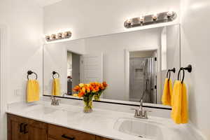 Full bathroom with double vanity and curtained shower