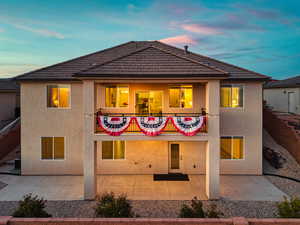 View of front of property with stucco siding and a patio area