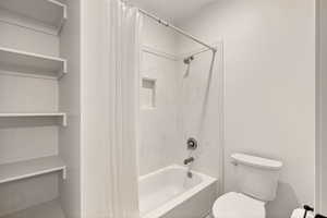 Bathroom with toilet and shower / tub combo
