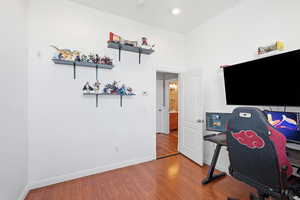 Home office with baseboards and wood finished floors