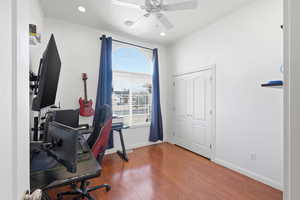 Home office with wood finished floors, ceiling fan, and recessed lighting