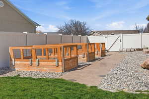 Wooden terrace with a gate and a fenced backyard