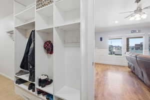 Mudroom featuring a ceiling fan, wainscoting, a decorative wall, recessed lighting, and light wood-style floors