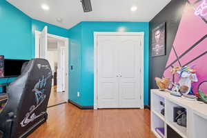 Office with light wood-style floors and baseboards