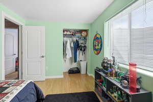 Bedroom with a closet and light wood-style flooring