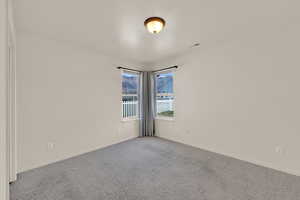 Empty room with carpet floors and baseboards