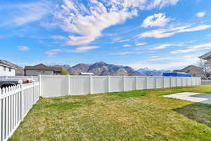 Fenced backyard with a mountain view