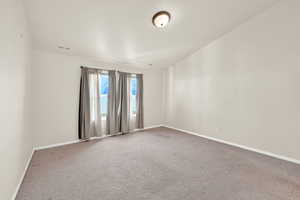 Carpeted empty room with baseboards
