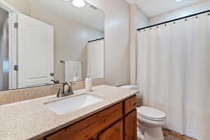 Bathroom with vanity and a shower with shower curtain