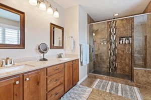 Bathroom with a shower stall and double vanity