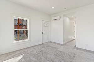 Foyer with light carpet and recessed lighting