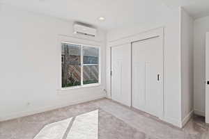 Unfurnished bedroom with light colored carpet, a closet, and recessed lighting