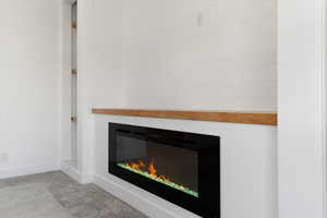 Detailed view of carpet flooring and a glass covered fireplace