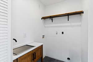 Laundry room featuring washer hookup and cabinet space