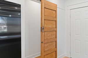 Detailed view of refrigerator and baseboards