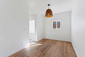 Empty room featuring light wood finished floors and baseboards