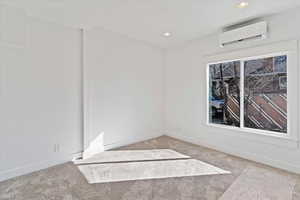 Unfurnished room with light carpet and recessed lighting