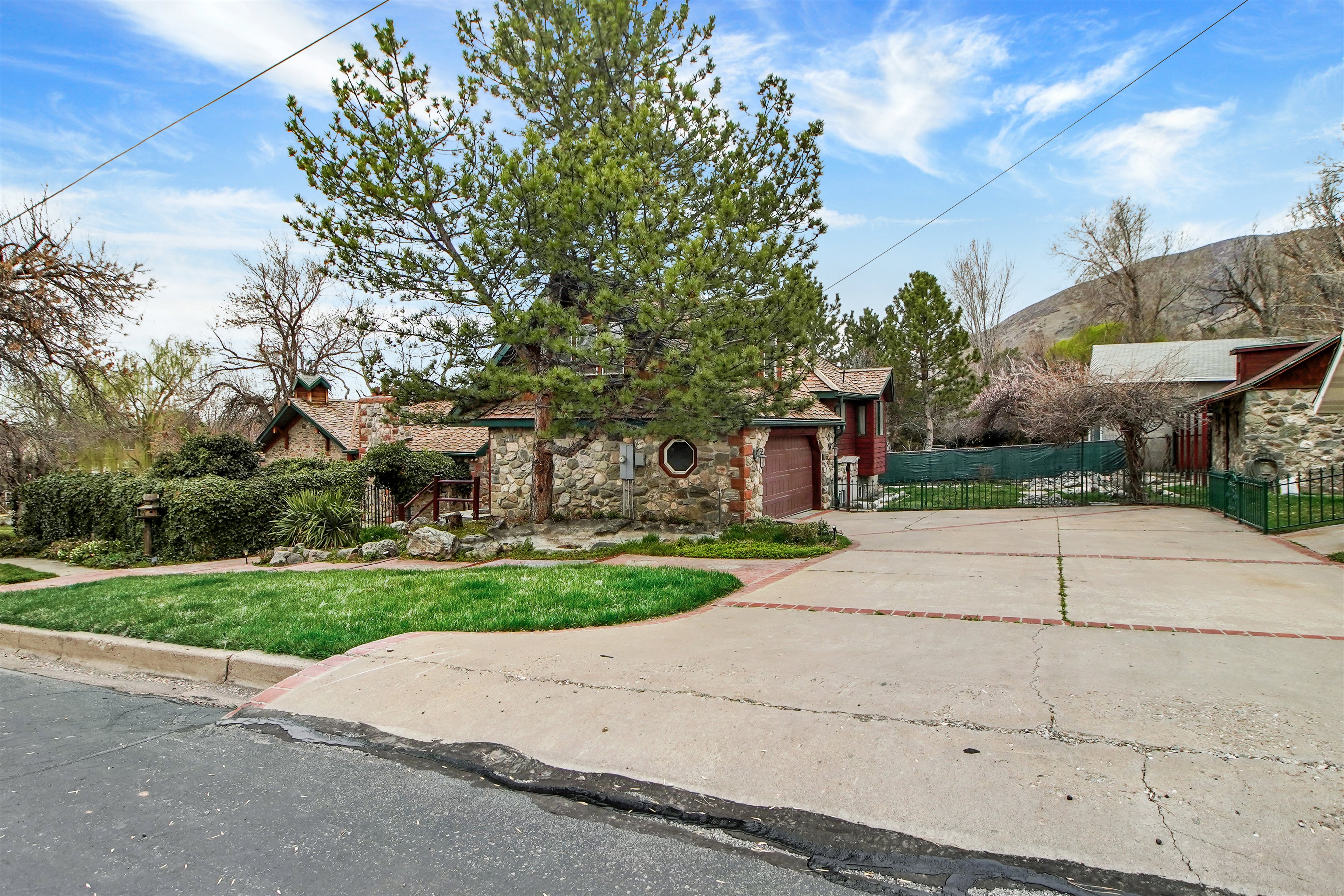 View of front of property with stone siding and driveway