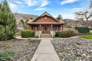 View of front of home with a porch and a mountain view
