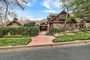 Tudor-style house featuring stone siding