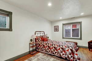Bedroom featuring light wood-style flooring, recessed lighting, and a baseboard heating unit