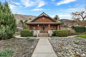 View of front of property featuring covered porch and a mountain view