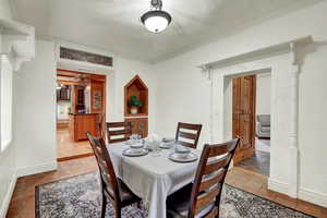 Dining area featuring ornamental molding and baseboards