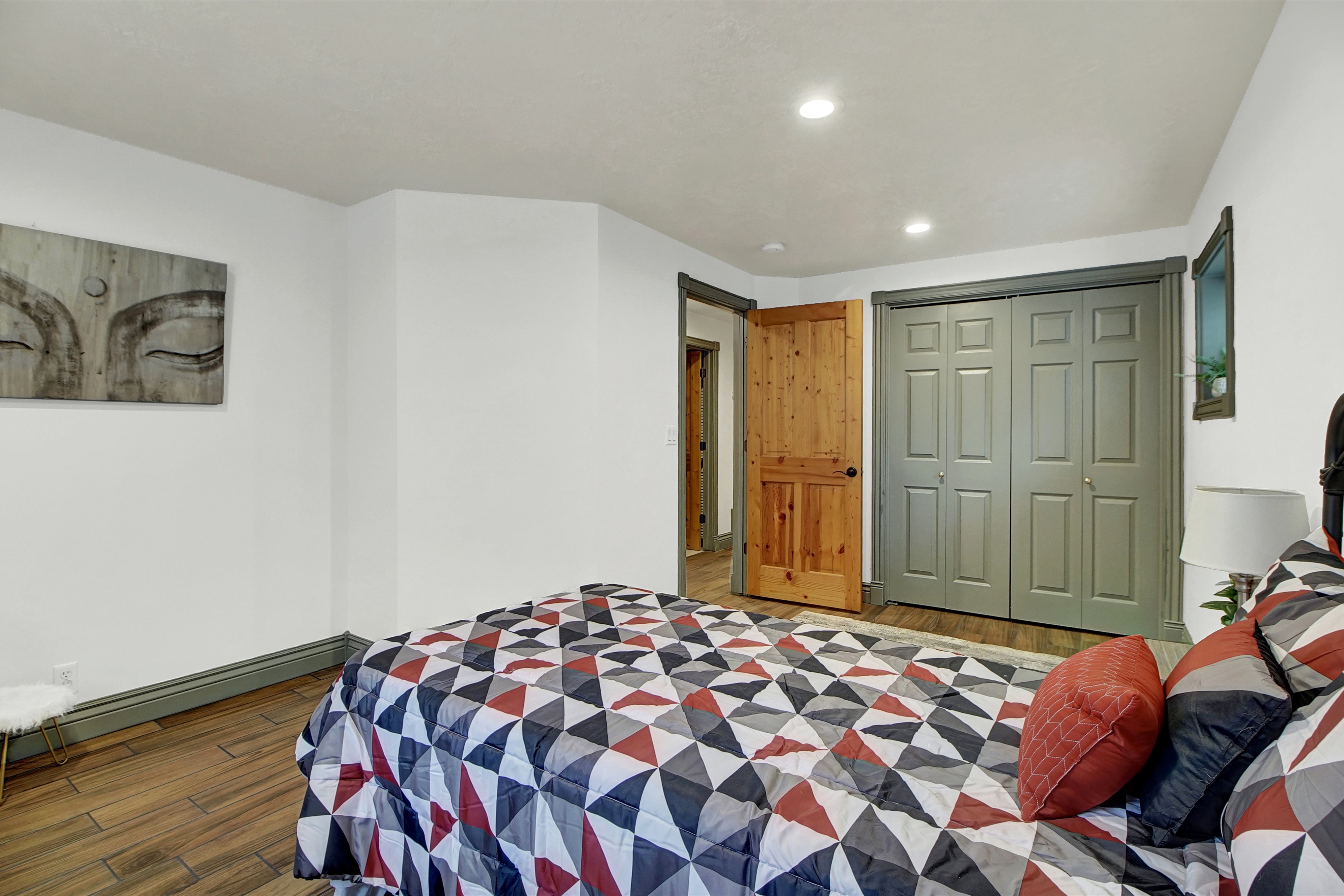 Bedroom featuring wood finished floors, a closet, and recessed lighting
