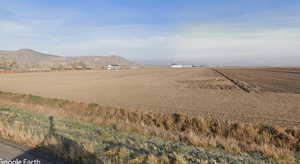 View of mountain backdrop featuring rural landscape