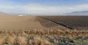Water view featuring rural landscape and mountains