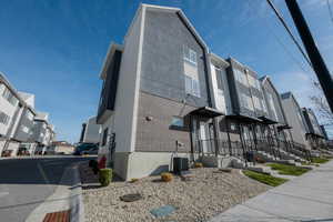 View of side of property with brick siding and a residential view