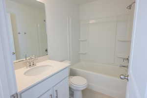 Full bathroom with vanity, bathtub / shower combination, and light tile patterned flooring