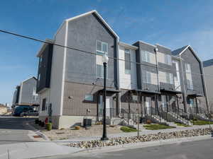 View of front of home featuring brick siding and stucco siding