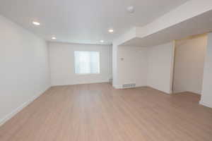 Unfurnished room featuring light wood-type flooring and recessed lighting
